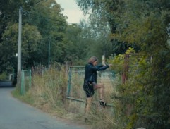 Lenka leze přes plot